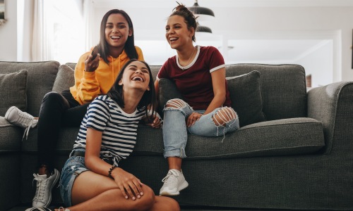 Fresh, fun and full of style people laughing in a living area